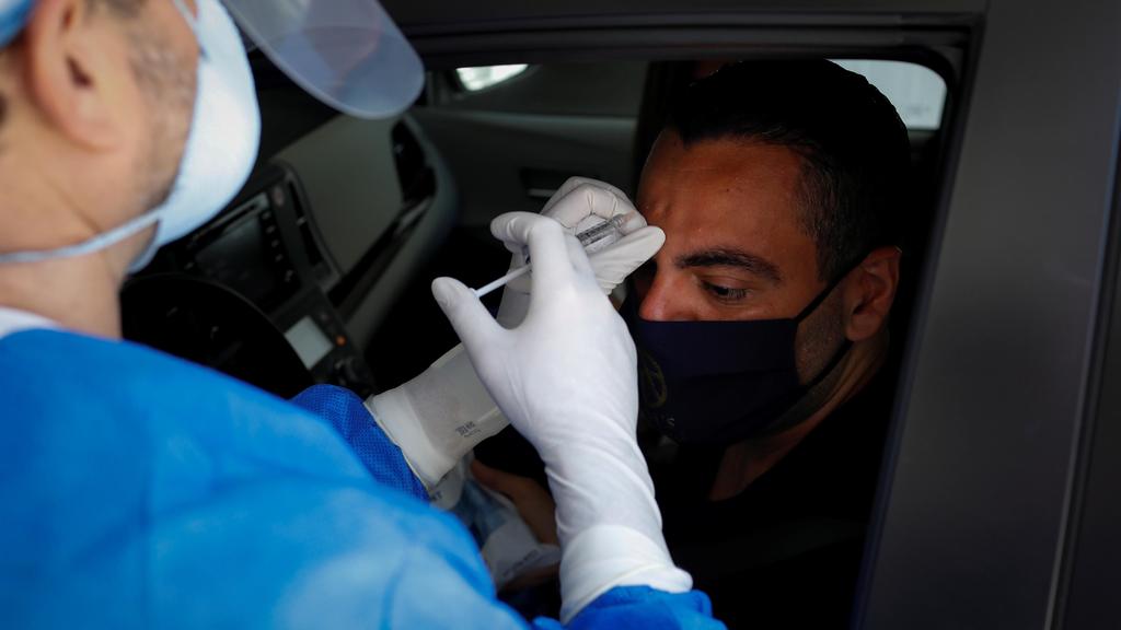 Michael Salzhauer, a plastic surgeon known as Dr. Miami, applies Botox to a patient while conducting drive-through Botox injections in the garage of his clinic 