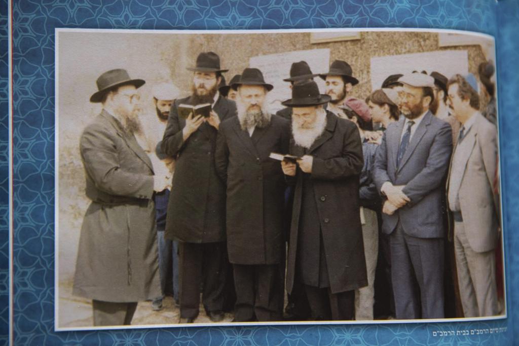 A photo book showing Rabbi Sholom Eidelman, third from left, who died after contracting the coronavirus, in Casablanca, Morocco