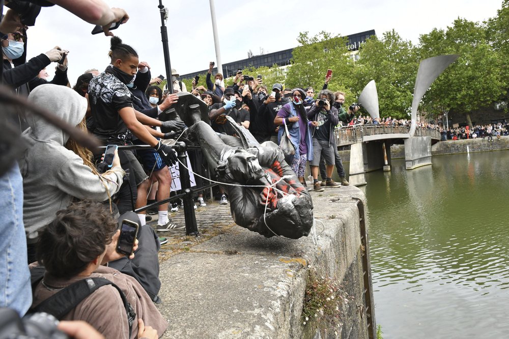 Protesters throw a statue of slave trader Edward Colston into Bristol harbour, during a Black Lives Matter protest rally, in Bristol, England 