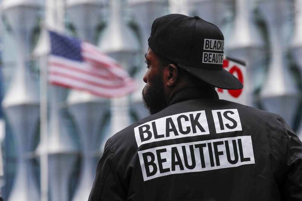 A protester stands in front of the US embassy during the Black Lives Matter protest rally in London 