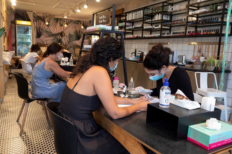 Customers visit a nail salon in Tel Aviv 