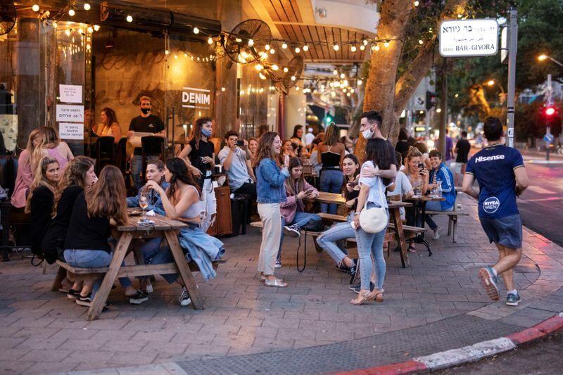 People enjoy themselves at the restaurant 'Denim' in Tel Aviv 