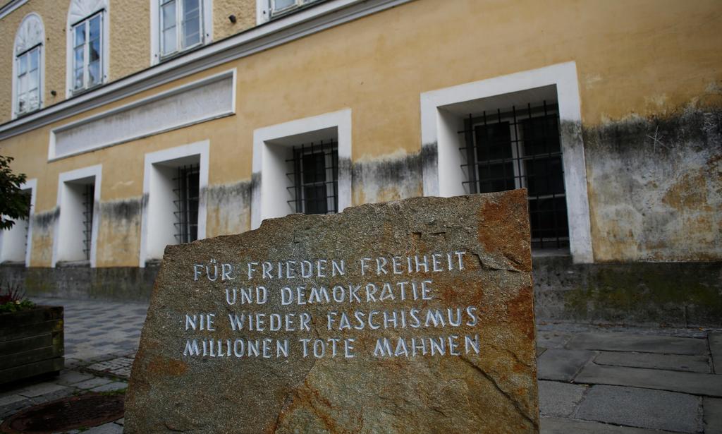 A memorial stone outside the house in which Adolf Hitler was born bears the inscription: 'For peace, freedom and democracy, never again fascism, millions of dead are a  warning' 