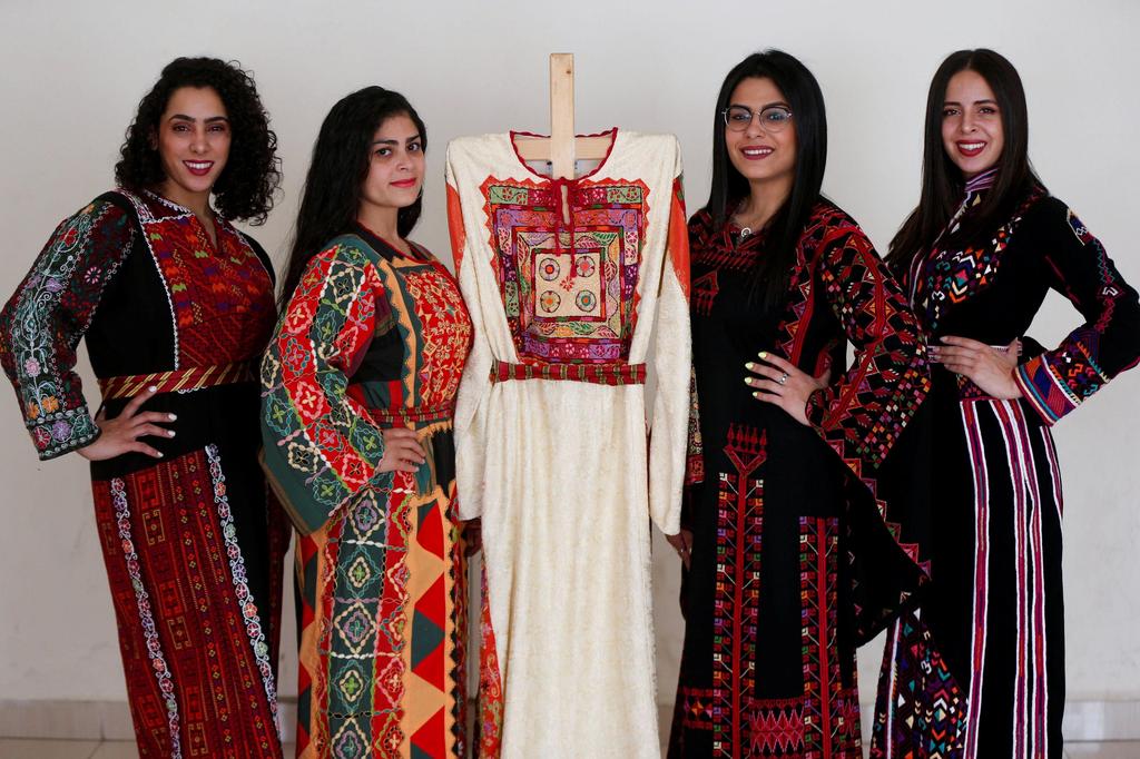 Models present traditional Palestinian dresses at Al Hanouneh society for popular culture in Amman, Jordan 