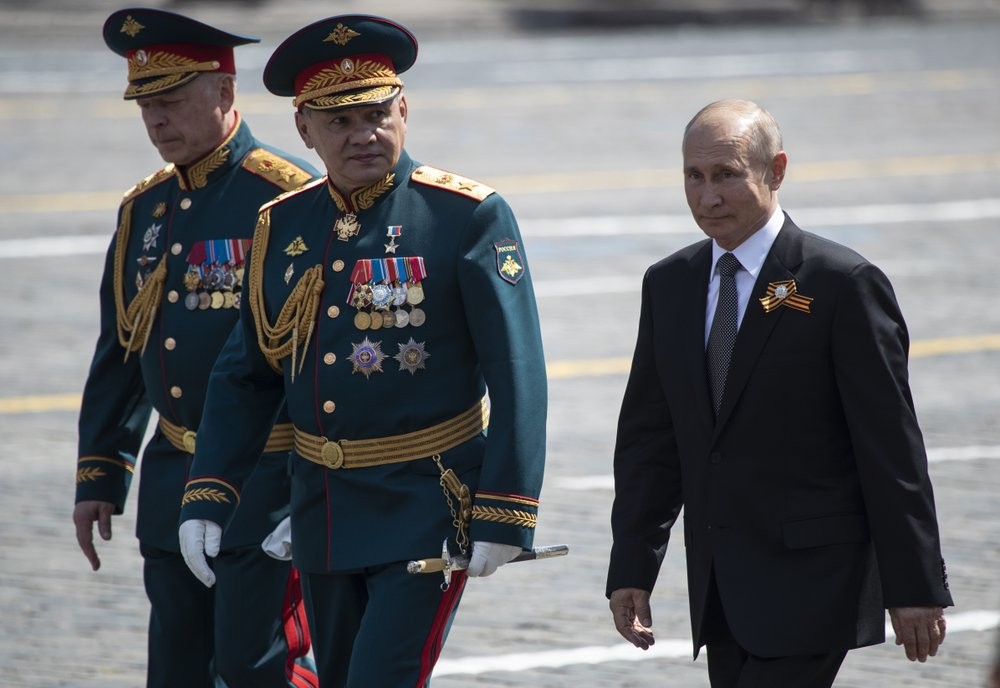 Russian President Vladimir Putin, right, and, Defense Minister Sergei Shoigu, center, leave Red Square after the Victory Day military parade marking the 75th anniversary of the Nazi defeat in Moscow, Russia 