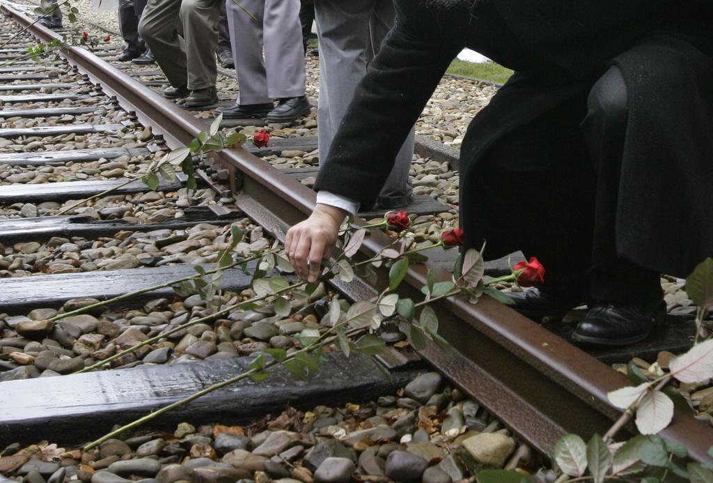 Roses are symbolically placed on the railroad tracks at former concentration camp Westerbork, the Netherlands 