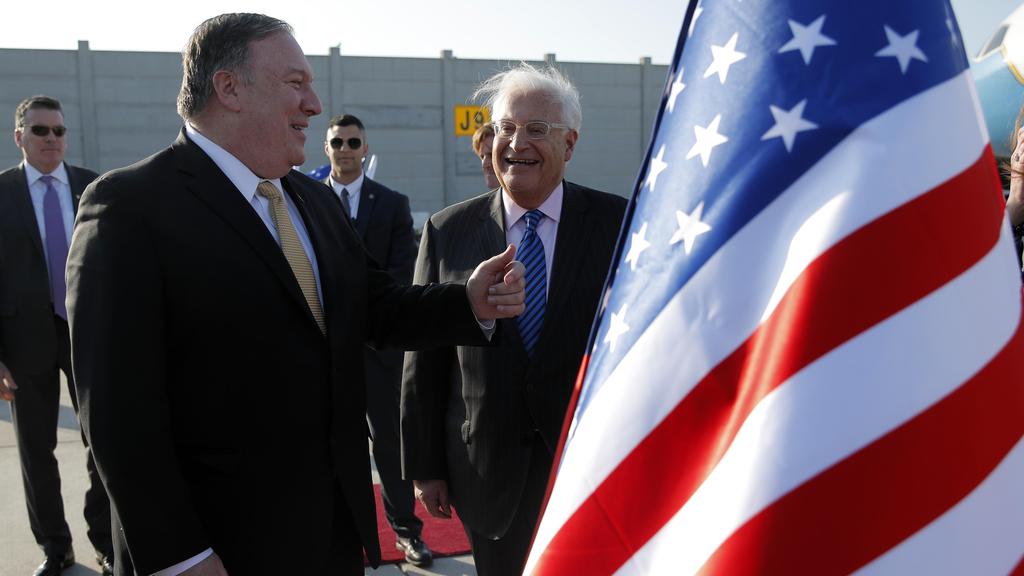 U.S. Secretary of State Mike Pompeo meets U.S. Ambassador to Israel David Friedman upon his arrival at Ben Gurion International Airport, near Tel Aviv