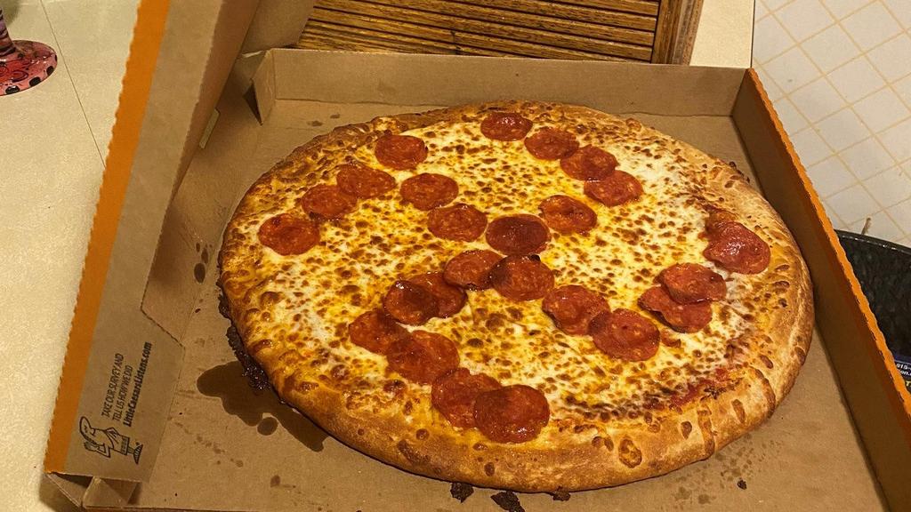 A pizza with pepperonis arranged in the shape of the swastika 