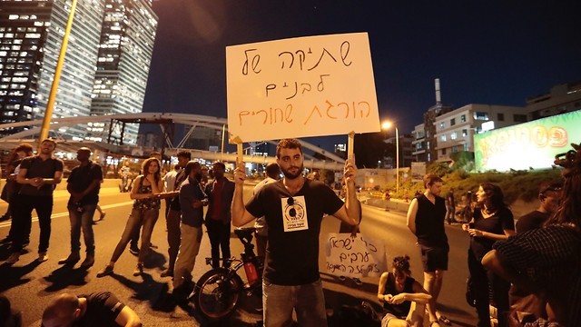 A n anti-racism protest in Tel Aviv,  July 2019. The banner reads: White silence kills black people 