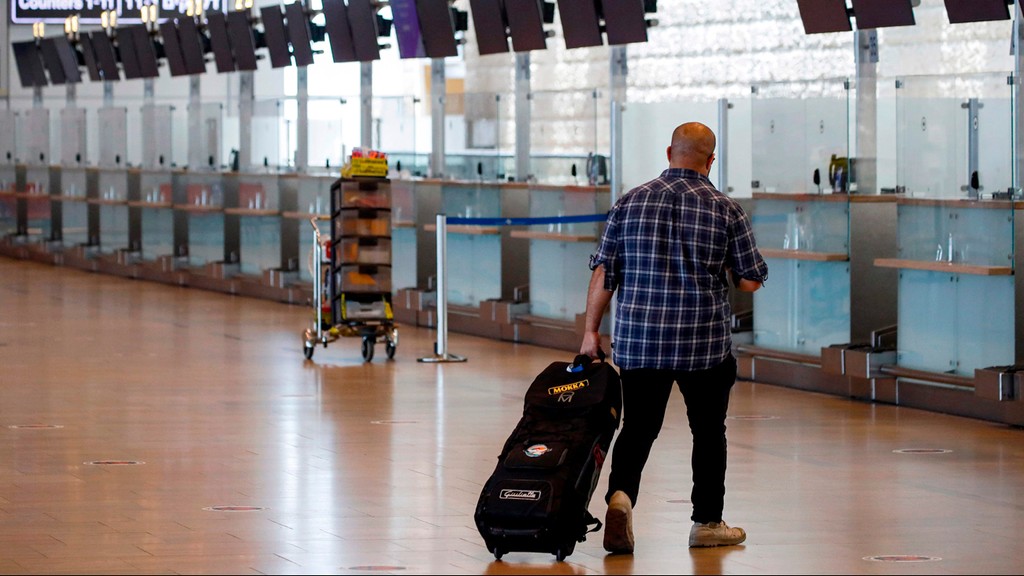 A traveler walks through a near-deserted Ben-Gurion Airport during the coronavirus pandemic 