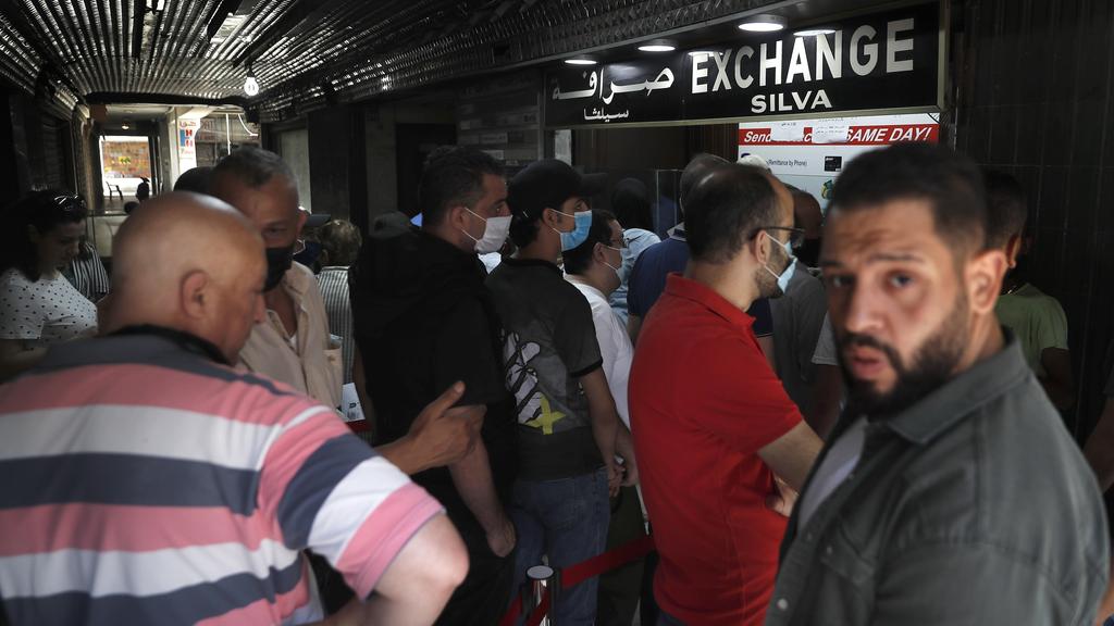 People line up outside an exchange shop to buy U.S. dollars, in Beirut, Lebanon