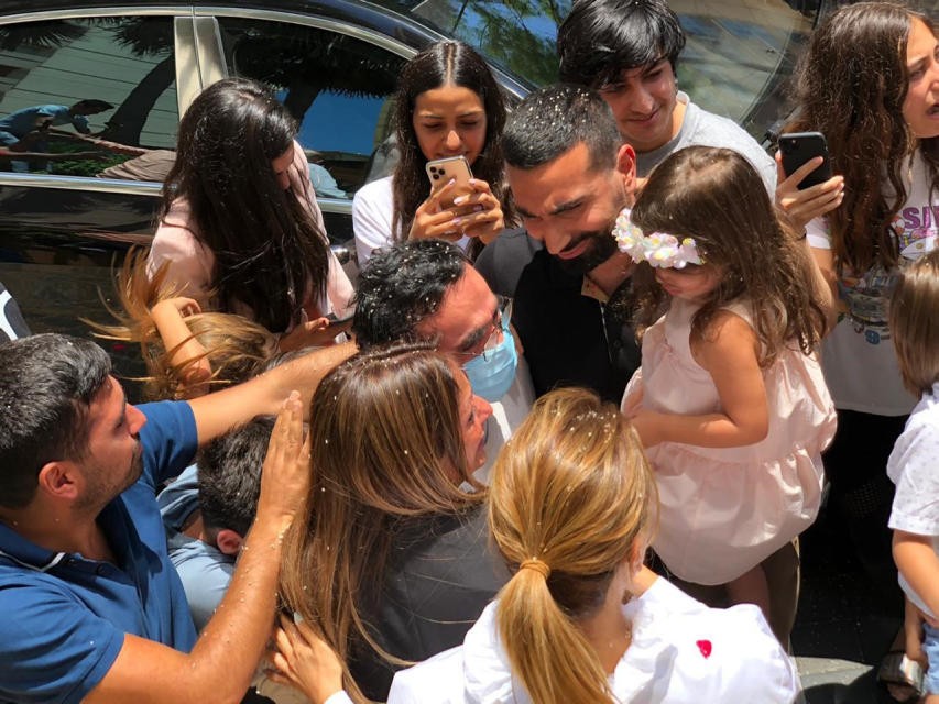 Kassim Tajideen is greeted by relatives upon arrival at his Beirut home, July 8, 2020 
