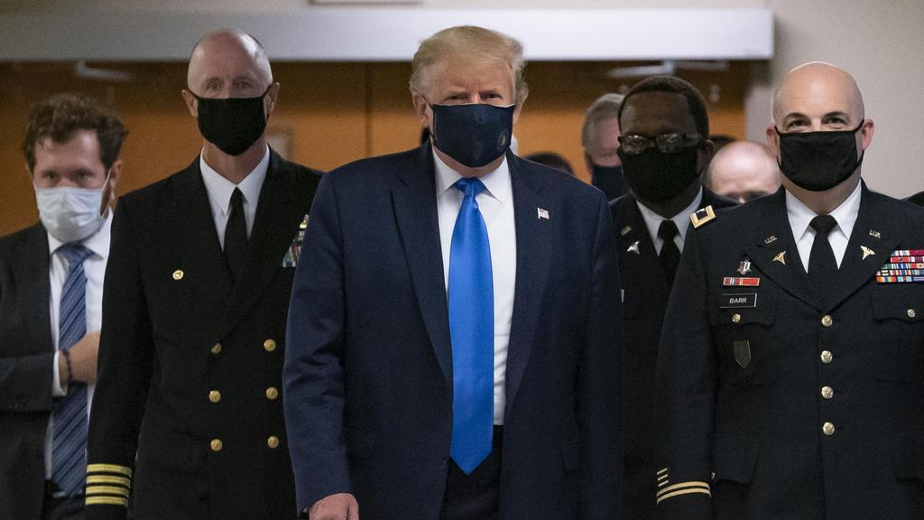 U.S. President Donald Trump wears a mask while visiting Walter Reed National Military Medical Center 