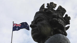 דגל אוסטרליה לצד פסל המלכה אליזבת ב בניין הפרלמנט ב קנברה