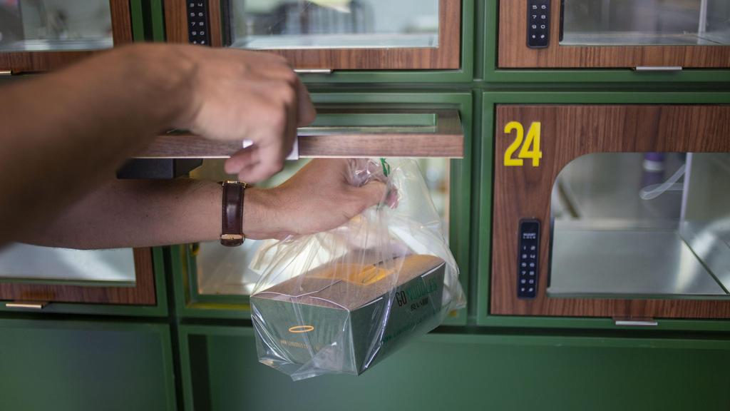 A Go Noodles box is taken by an employee from a glass-paned locker in Tel Aviv, Israel,