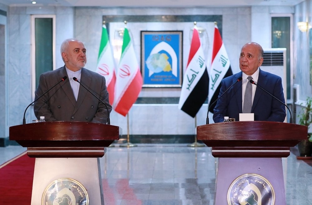 Iraqi Foreign Minister Fouad Hussein, right, and visiting Iranian counterpart Mohammad Javad hold a news conference following their meeting in Baghdad, Iraq 