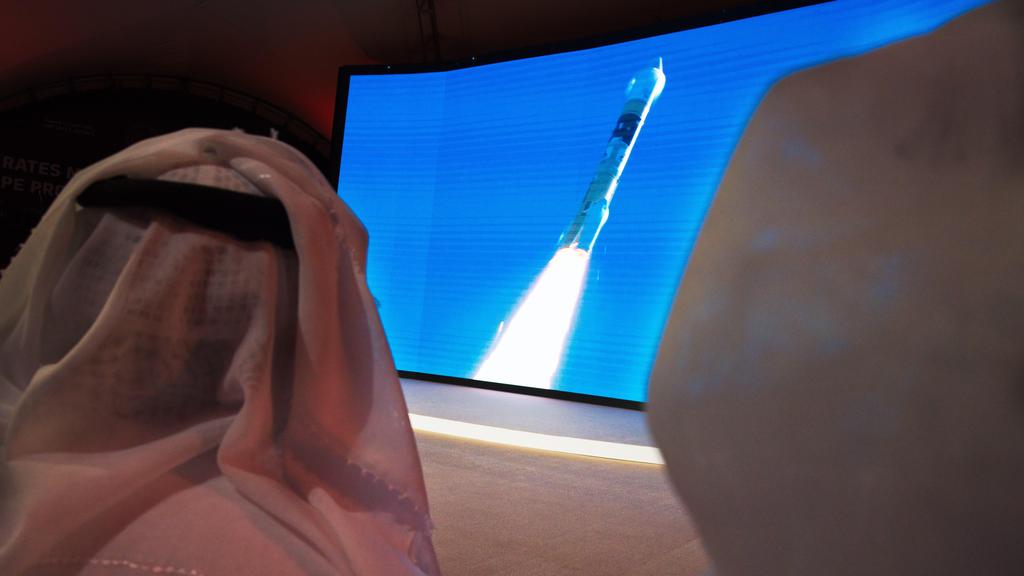 Emirati men watch the launch of the "Amal" space probe