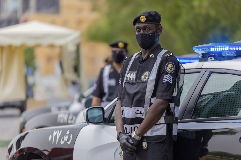 Policemen wearing gloves and face masks to help prevent the spread of the coronavirus, provide security for pilgrims, in Mecca, Saudi Arabia 