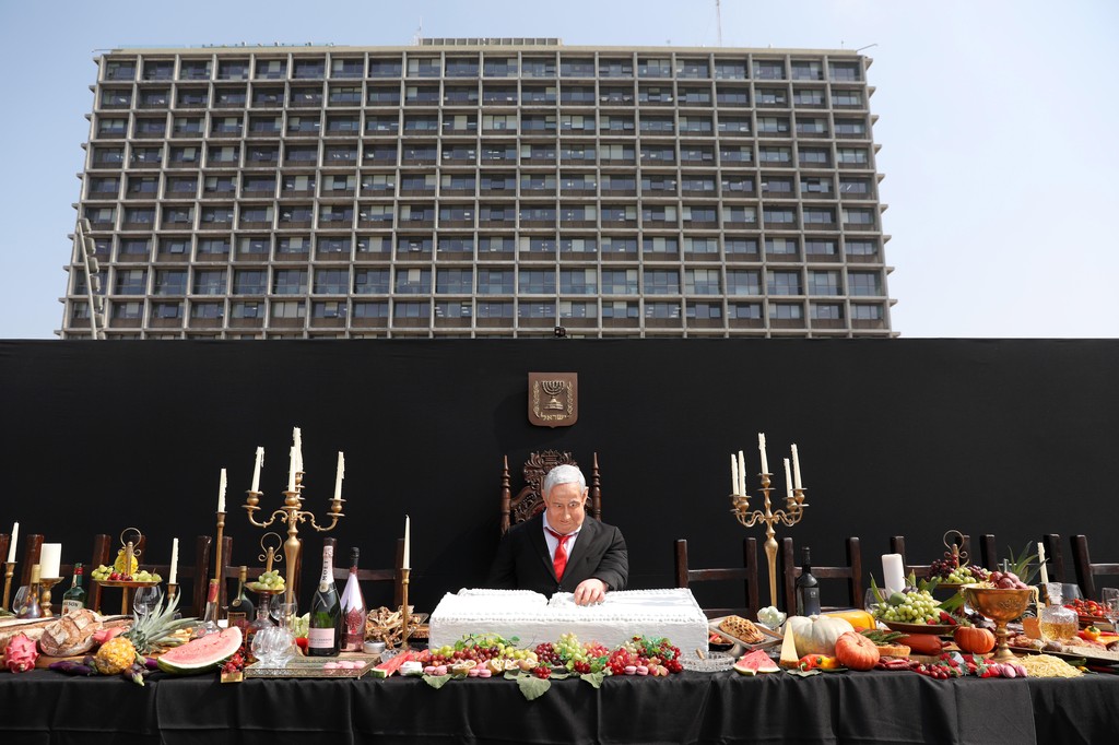 A statue depicting Prime Minister Benjamin Netanyahu sitting in the spirit of 'The Last Supper' is displayed as a protest performance by Israeli artist Itai Zalait, in Rabin Square, Tel Aviv, July 29, 2020 