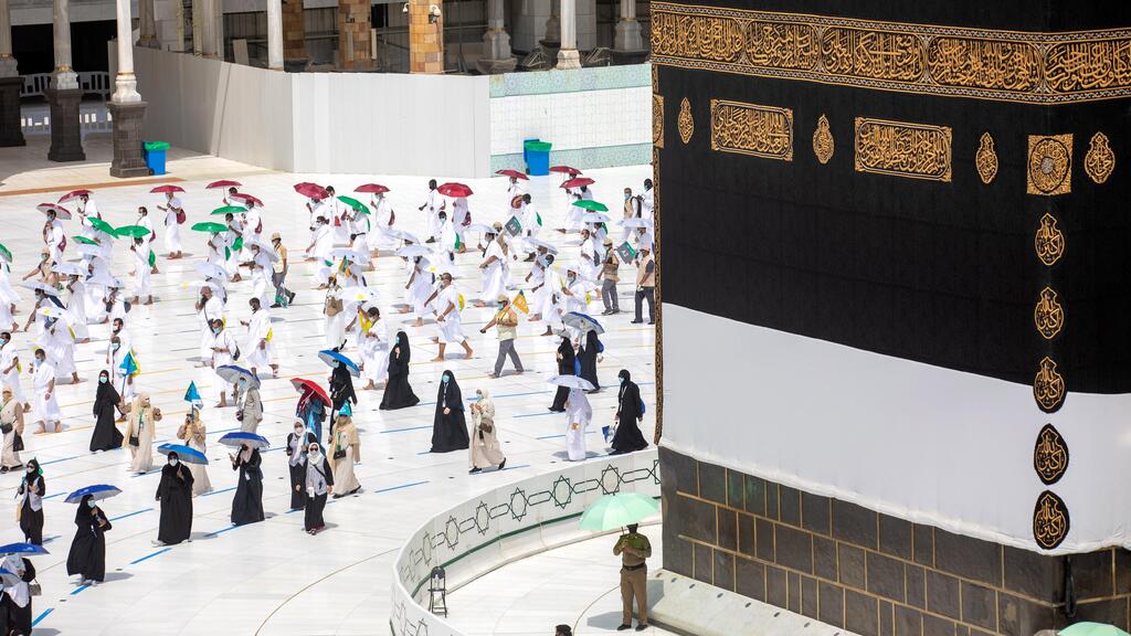 Pilgrims circle around the Kaaba at the Grand Mosque in Mecca on the first day of Hajj, July 29, 2020 