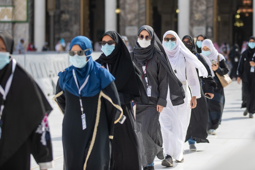 Pilgrims wear masks and maintain social distancing as they enter the Grand Mosque in Mecca on the first day of Hajj, July 29, 2020 