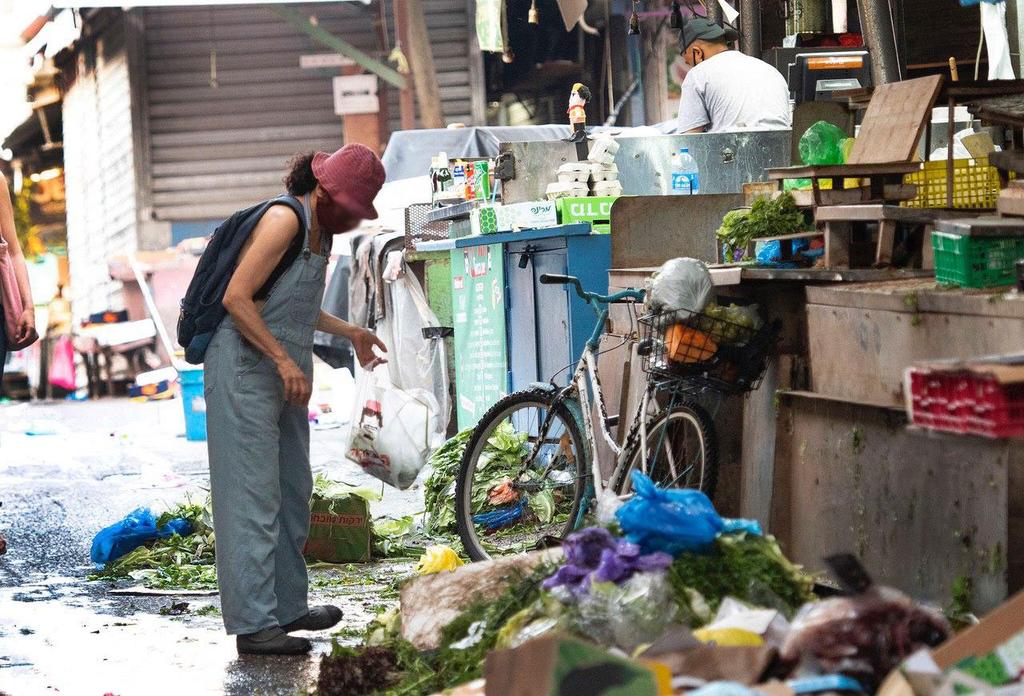 אנשים מחפשים אוכל בפחים בצל משבר הקורונה