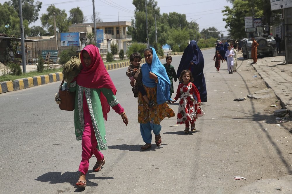 Afghan family leave their houses after an attack on a prison in the city of Jalalabad, east of Kabul, Afghanistan 