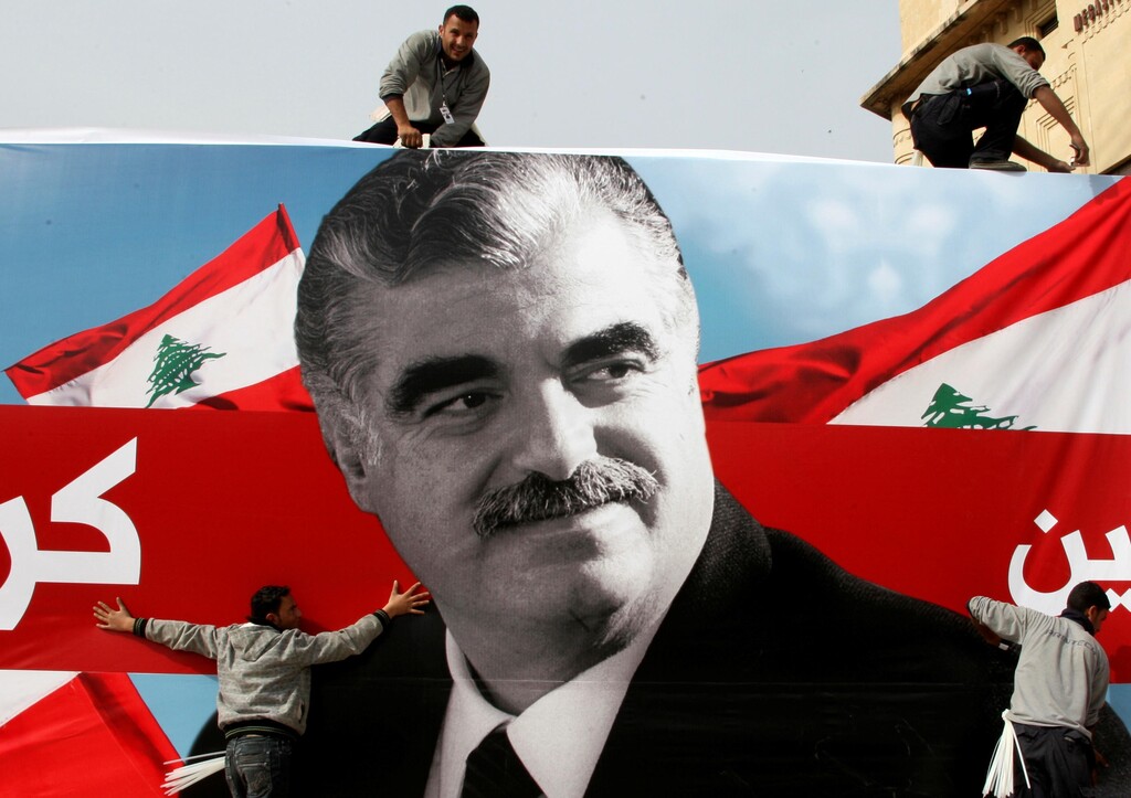 Workers prepare a giant poster depicting Lebanon's assassinated former prime minister Rafik al-Hariri, in downtown Beirut, Lebanon February 12, 2010 