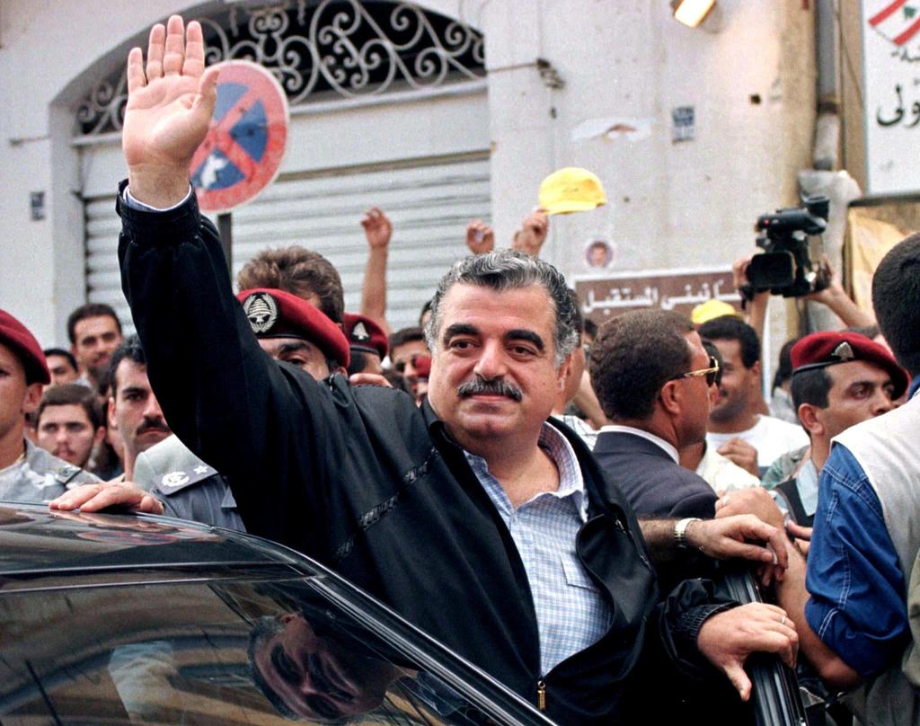 Lebanese Prime Minister Rafik al-Hariri waves to supporters after casting his vote at a Beirut polling station in Lebanon September 1, 1996 