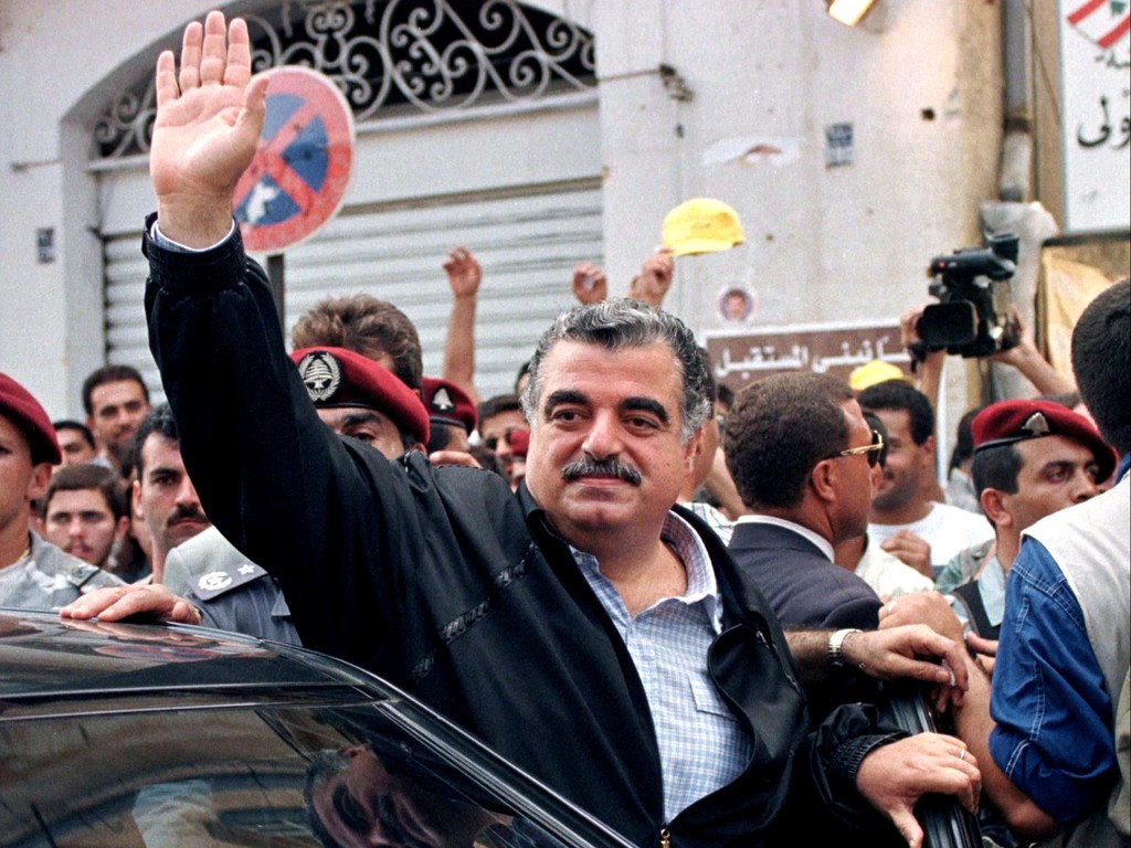 Lebanese Prime Minister Rafik al-Hariri waves to supporters after casting his vote at a Beirut polling station in Lebanon September 1, 1996 
