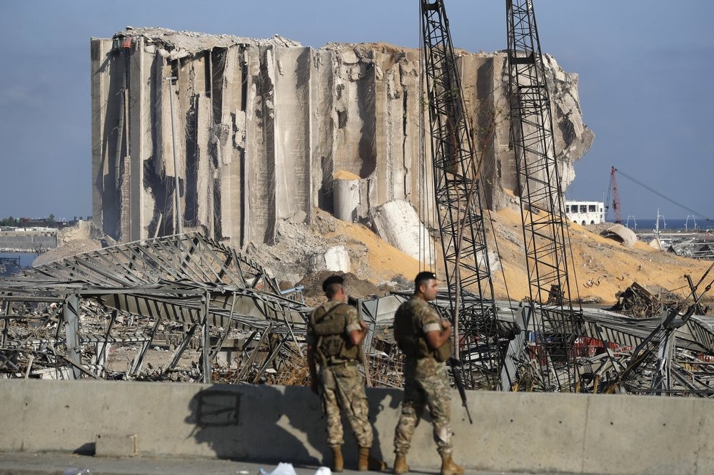 Lebanese army soldiers stand guard at the scene where an explosion hit on Tuesday the seaport of Beirut, Lebanon 