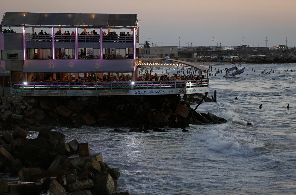 Palestinians sit at a beachfront cafe in Gaza City 