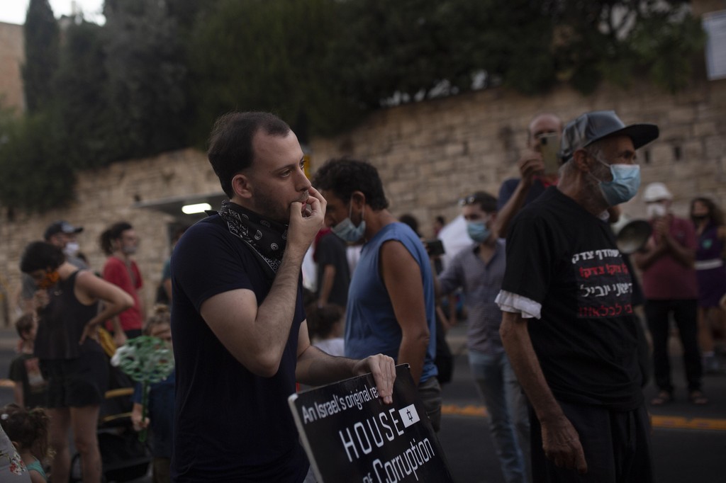 Shachar Oren, 25, whistles during a protest against Israel's Prime Minister Benjamin Netanyahu outside his residence in Jerusalem 