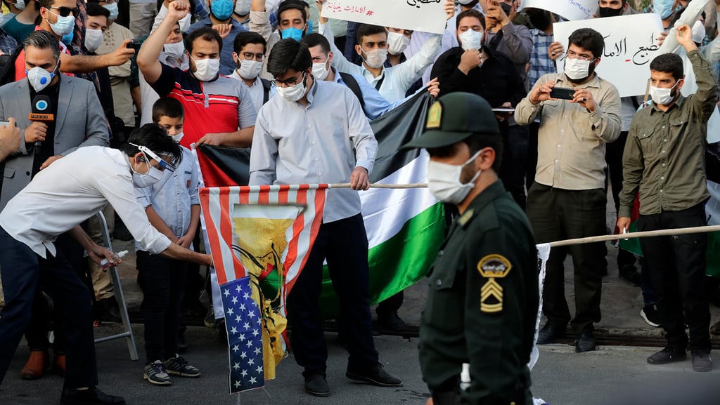  Protesters in Iran burn American flag 