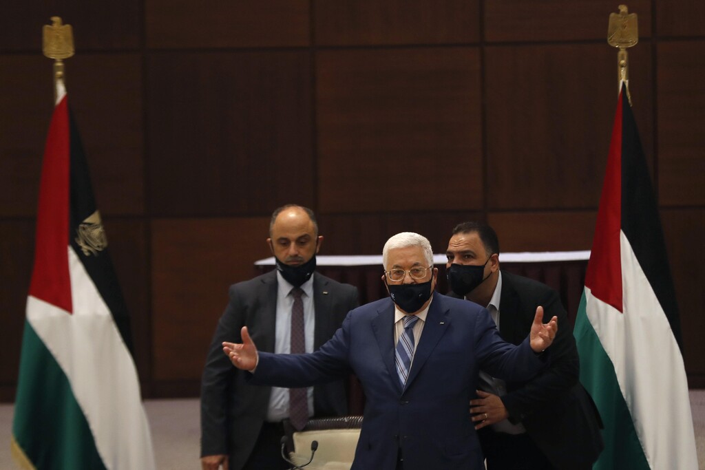 President Mahmoud Abbas gestures during a meeting with the Palestinian leadership to discuss the United Arab Emirates' deal with Israel to normalize relations,