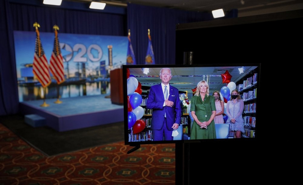 Democratic presidential candidate former Vice President Joe Biden is seen in a video feed from Delaware with his wife Jill Biden, and his grandchildren at his side 