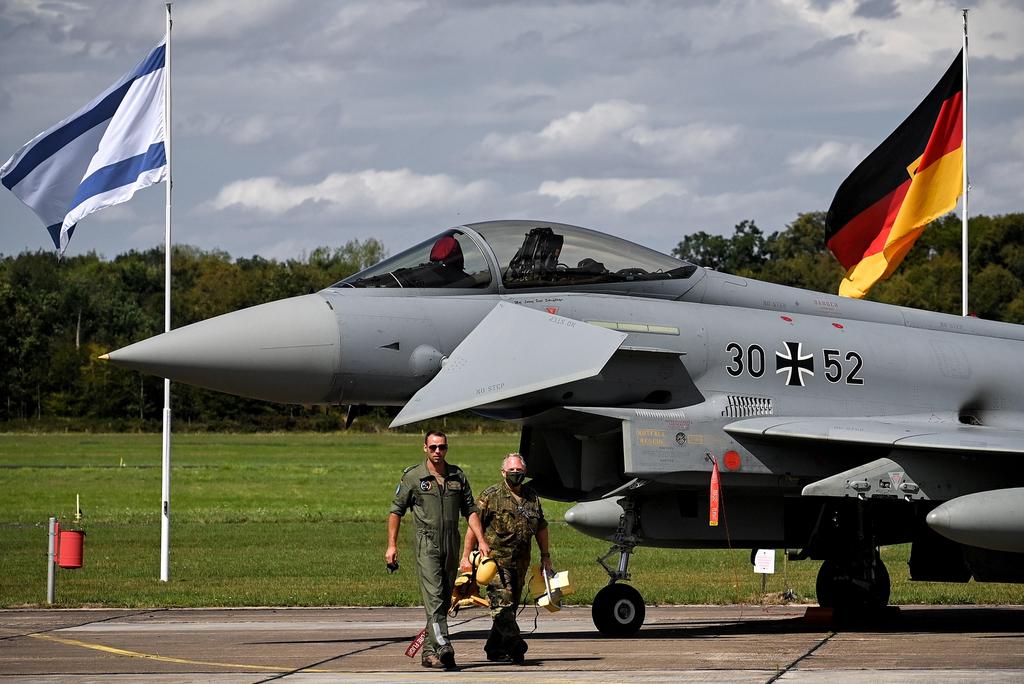 Flags of Israel (L) and Germany fly behind a Bundeswehr Eurofighter during the joint German-Israeli military excercise Blue Wings 2020 in Noervenich, Germany