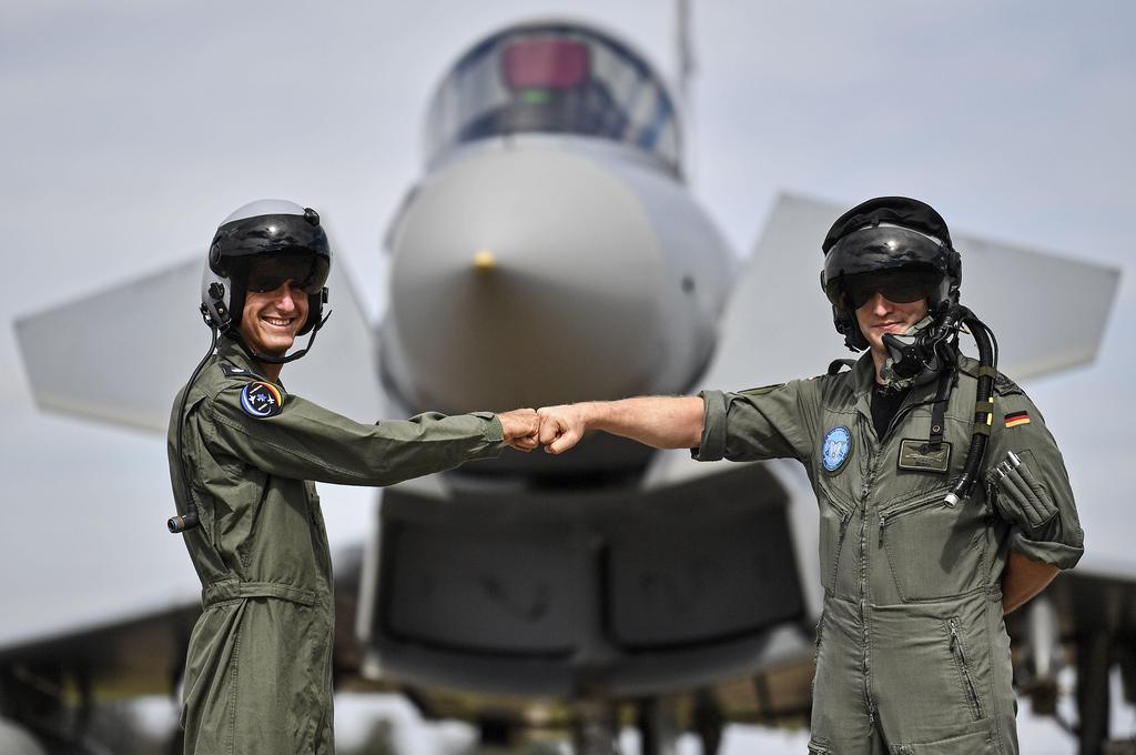  pilot from Israel, left, and a pilot from Germany, right, pose in front of an Eurofighter at the airbase in Noervenich, Germany
