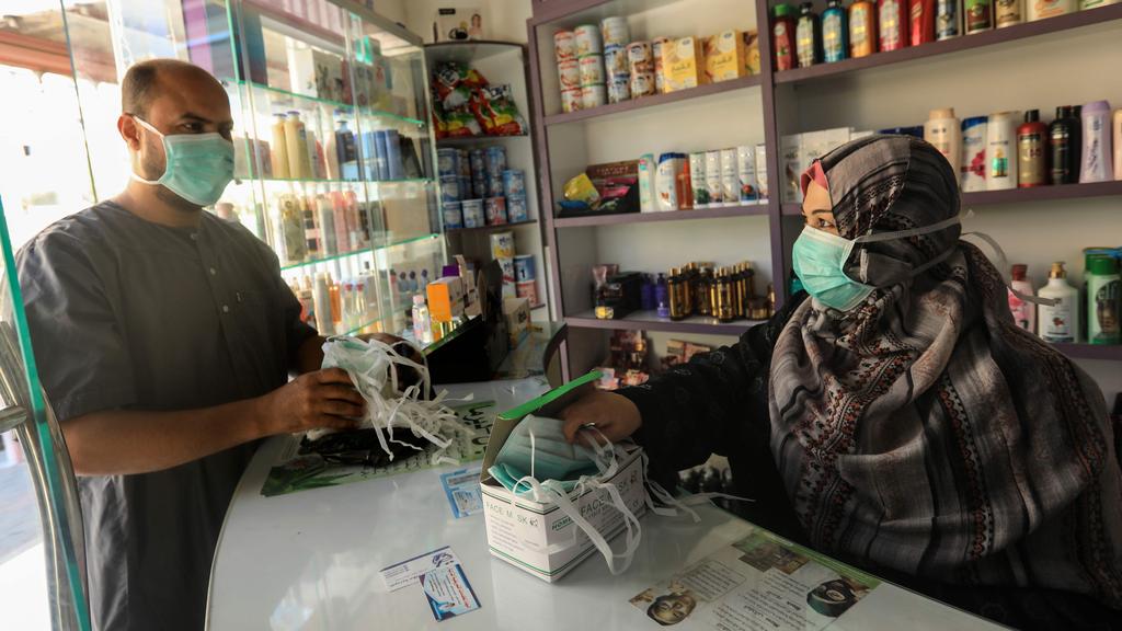 A Palestinian buys masks to use for protection against the spread of the coronavirus virus during lockdown in Gaza
