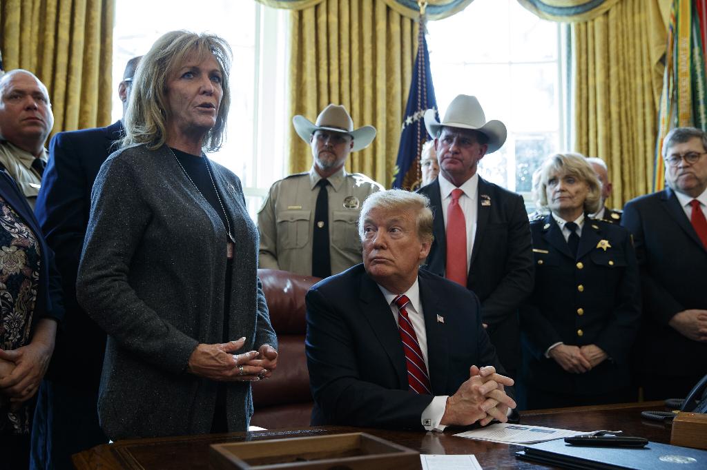 Mary Ann Mendoza (L) standing next to U.S. President Donald Trump 