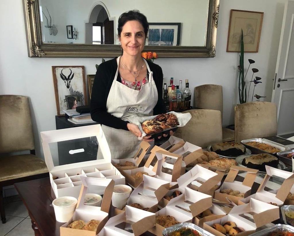Elli Kriel with Shabbat food she prepared for hungry guests 