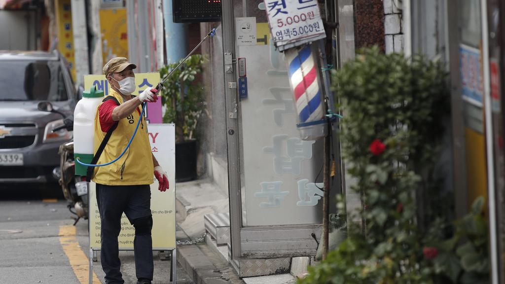 A man disinfects as a precaution against the coronavirus in Seoul, South Korea