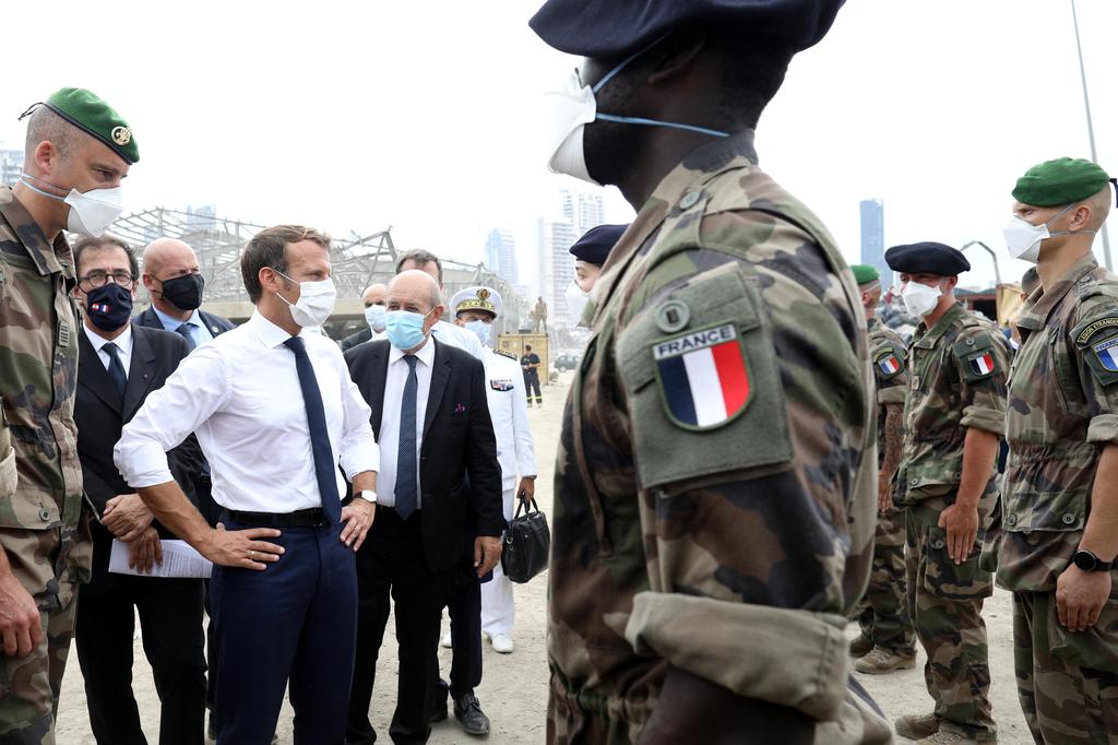 French Foreign Minister Jean-Yves Le Drian and French President Emmanuel Macron meet members of the military mobilized for the reconstruction of the port of Beirut, Sept. 1, 2020 