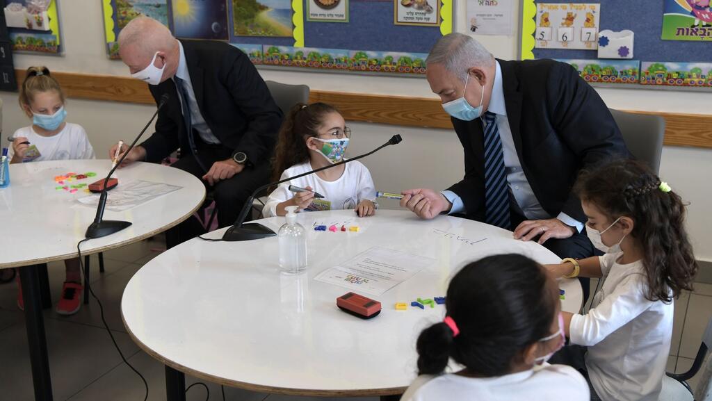 Prime Minister Benjamin Netanyahu, right, and Education Minister Yoav Galant, join first graders at the start of the school year in the West Bank settlement of Mevo Horon 