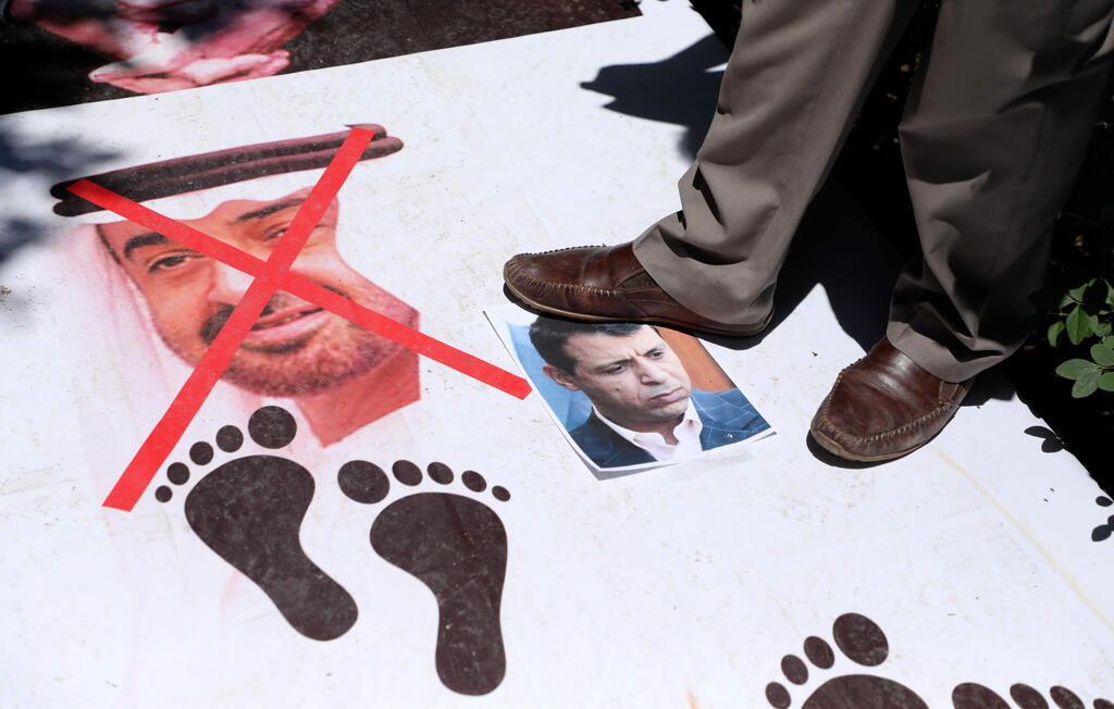 Palestinian protestors step on portraits of Abu Dhabi Crown Prince Sheikh Mohammed bin Zayed Al-Nahyan, and Palestinian politician Mohammed Dahlan, during a national conference against the Emirati-Israeli agreement