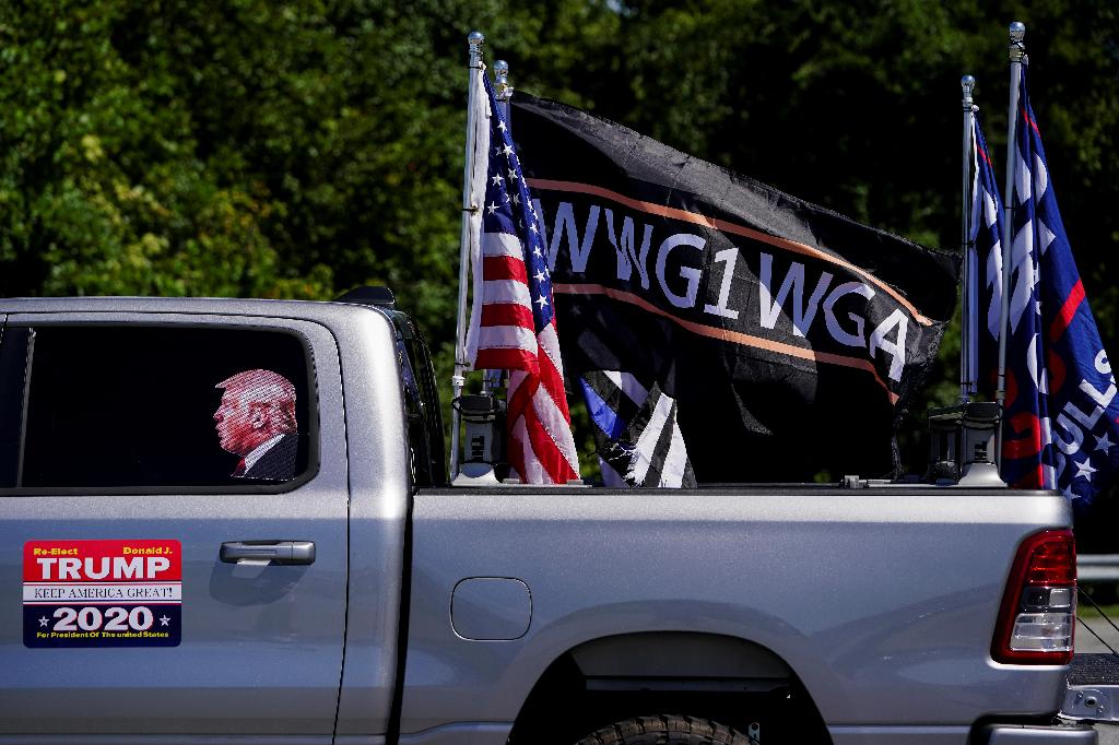 Pro-Trump flags and a flag reading WWG1WGA, a reference to the QAnon slogan is seen on a truck that participated in a caravan convoy in Adairsville, Georgia, U.S. 