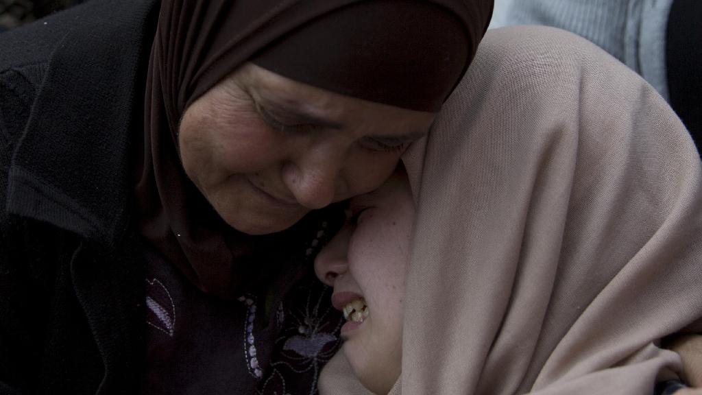  Relatives of Palestinian Ahmad Manasra mourn during his funeral in the West Bank village of Wad Fokin, near Bethlehem