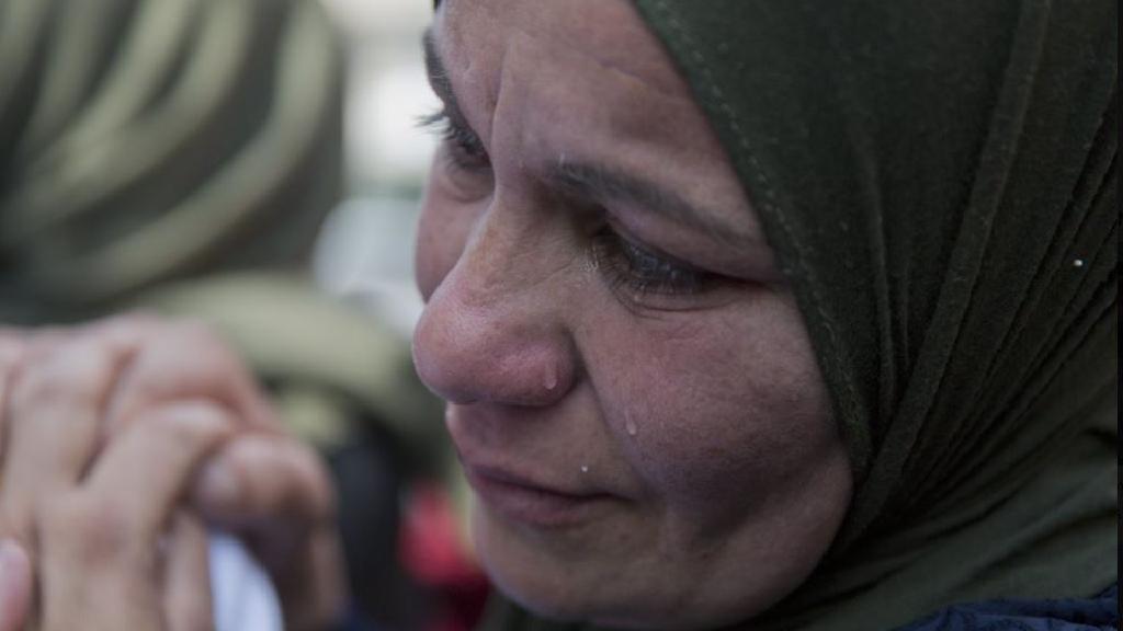 A relative of Palestinian Ahmad Manasra cries during his funeral in the West Bank village of Wad Fokin