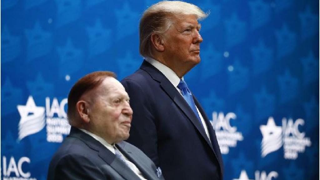resident Donald Trump stands alongside Sheldon Adelson