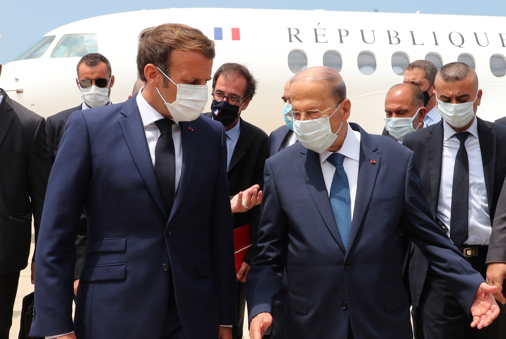 Lebanon's President Michel Aoun welcomes French President Emmanuel Macron upon his arrival at the airport in Beirut, Lebanon 